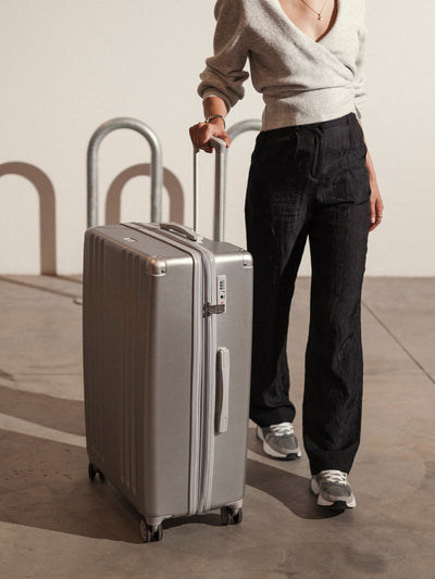 Studio product shot of front-facing CALPAK Ambeur large 30-inch silver hardshell spinner luggage; LAM1028-SILVER view 2