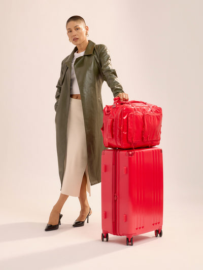 Studio product shot of front-facing CALPAK Ambeur medium 26-inch lightweight hardshell luggage with 360 spinner wheels in metallic red; LAM1024-METALLIC-RED view 2