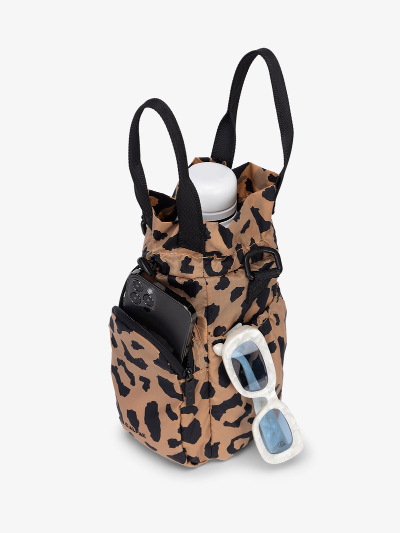 water bottle bag in cheetah print with phone and sunglasses