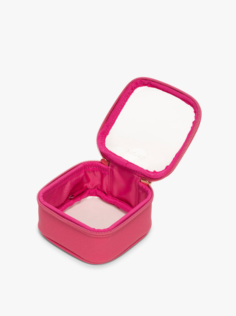 CALPAK Tiny Clear Cosmetic Case in bright pink Dragonfruit opened with zipper