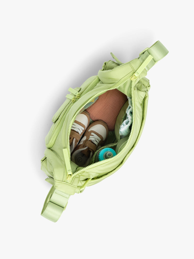 CALPAK Crossbody Diaper Bag in light green Lime top view with zipper opened, showing interior of bag