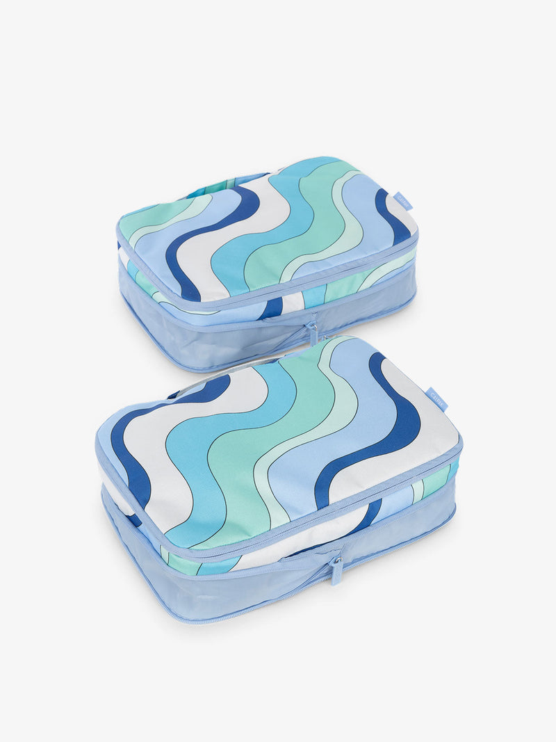 CALPAK compression packing cubes with handles in wavy blue print