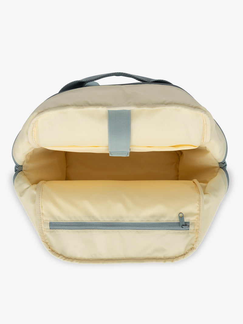 CALPAK Connect Laptop Backpack with multiple interior pockets and a padded laptop sleeve with blue exterior, yellow interior