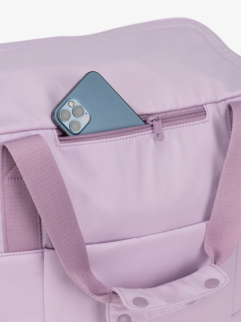 Zippered phone pocket of CALPAK Connect Laptop Duffel in berry purple