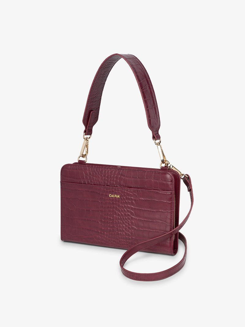 CALPAK travel wallet in faux croc textured burgundy