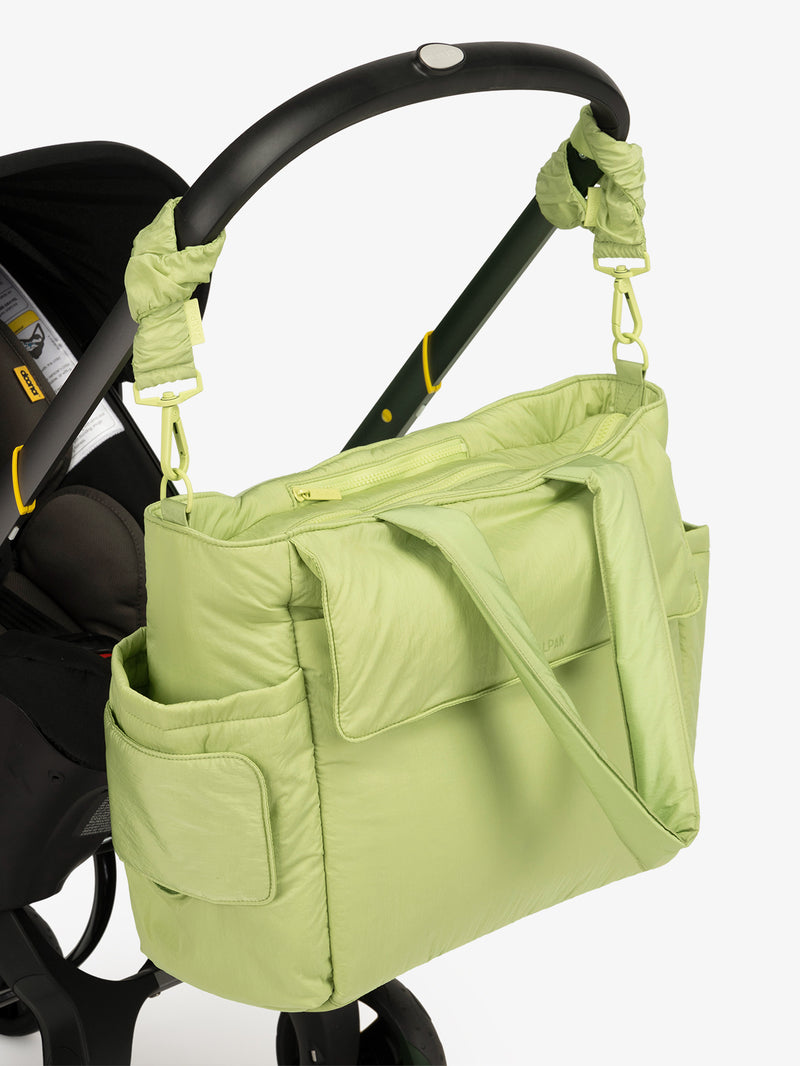 CALPAK Diaper Tote Bag in light green Lime with light green Lime Stroller Straps attached to a black stroller