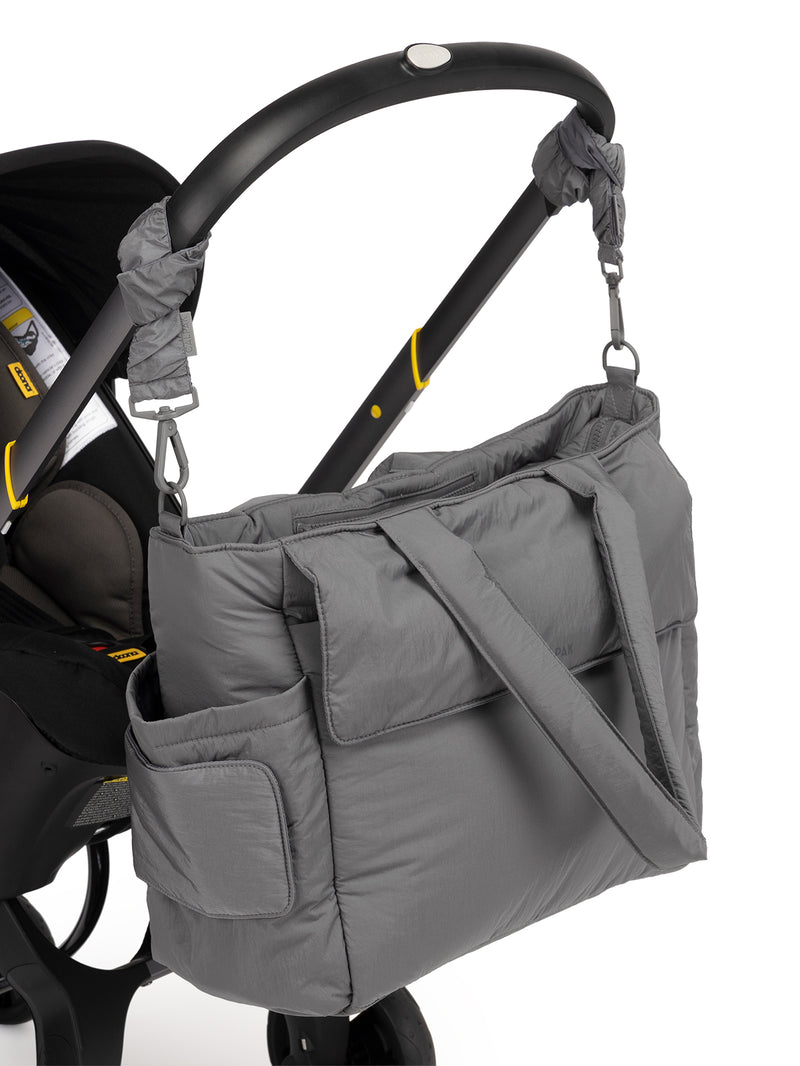 CALPAK Diaper Tote Bag in grey Slate with grey Slate Stroller Straps attached to a black stroller