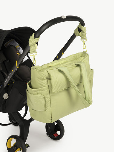 CALPAK Diaper Tote Bag with Stroller Straps attached to stroller handle in green lime; BTBB2401-LIME
