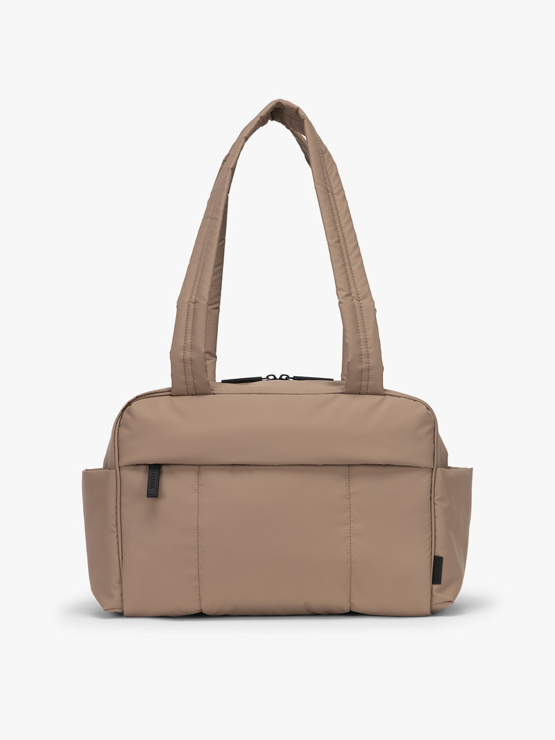 CALPAK Mini Duffel in brown Chocolate front view with puffy exterior, interior and exterior pockets, and padded shoulder straps
