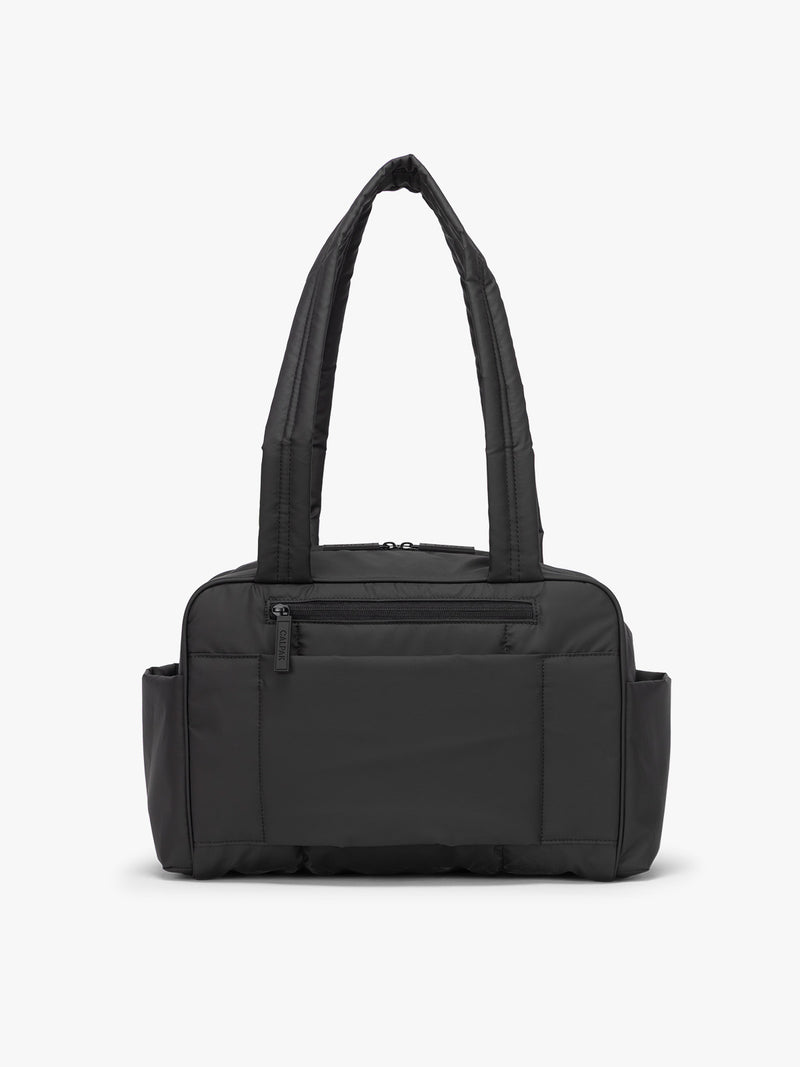 CALPAK Mini Duffel in black back view with zipper, puffy exterior, interior and exterior pockets, and padded shoulder straps