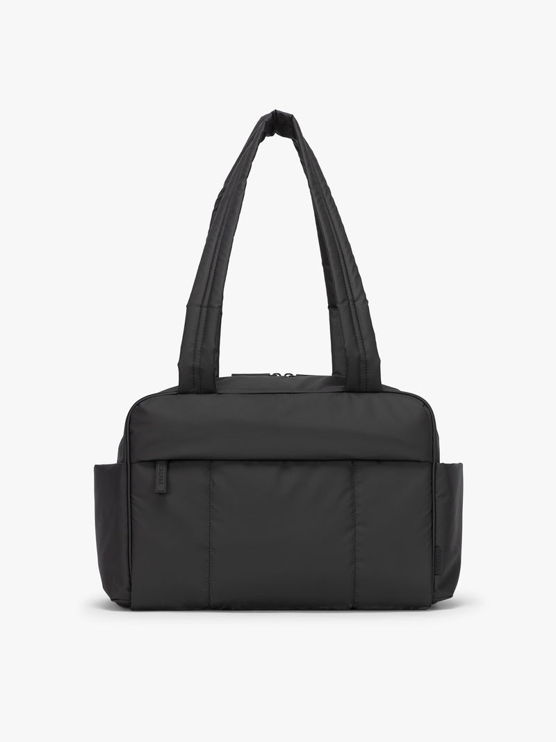 CALPAK Mini Duffel in black front view with puffy exterior, interior and exterior pockets, and padded shoulder straps