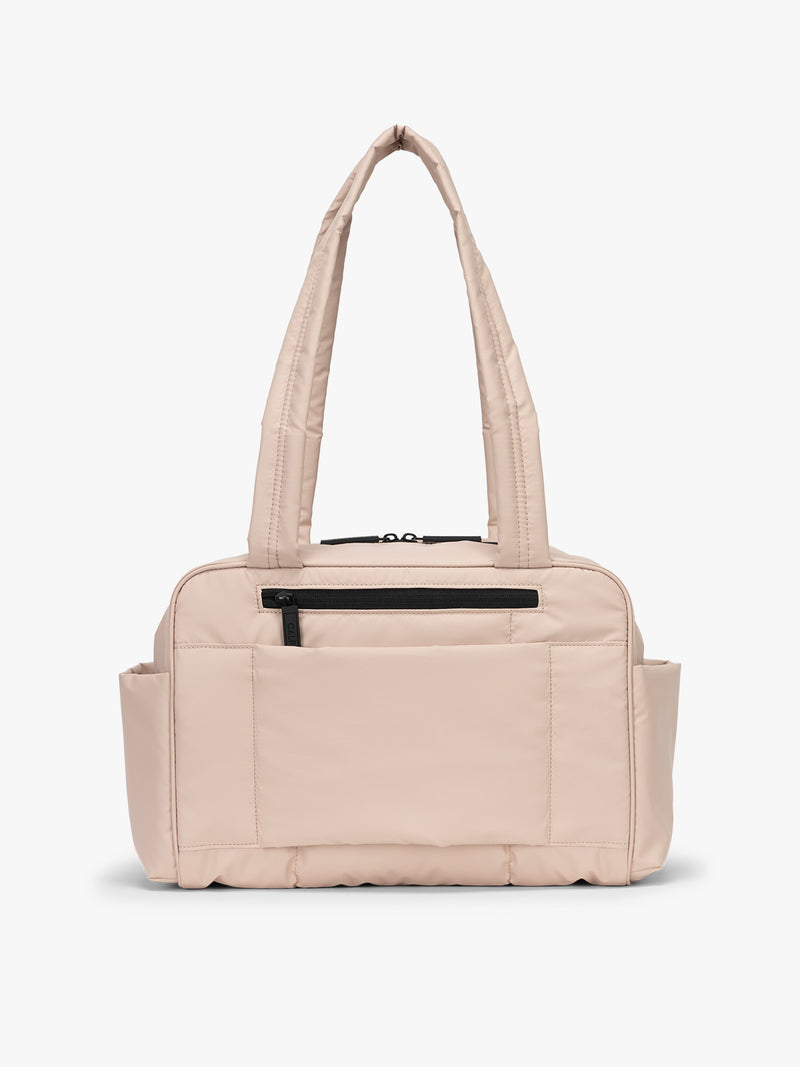 CALPAK Mini Duffel in light pink Rose Quartz with back view with zipper, puffy exterior, interior and exterior pockets, and padded shoulder straps