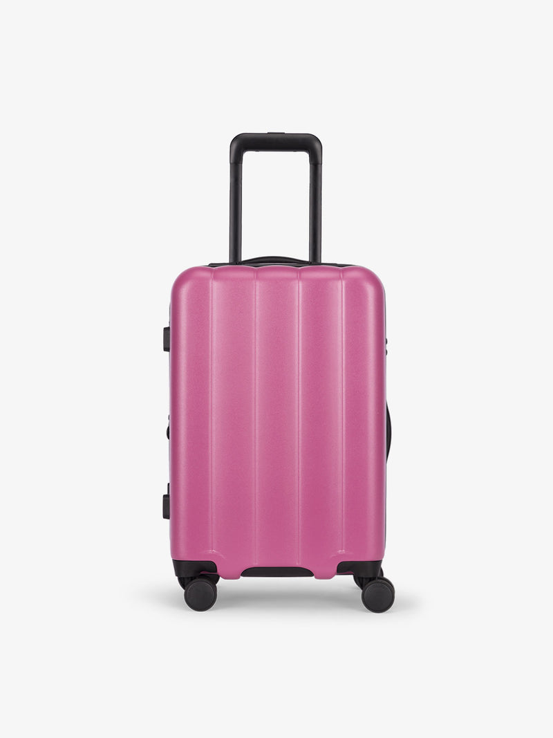 CALPAK Pacific blue carry-on luggage made from an ultra-durable polycarbonate shell and expandable by up to 2" in raspberry