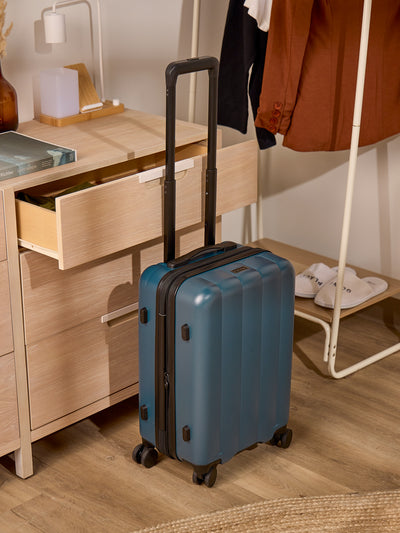 CALPAK Pacific blue carry-on luggage made from an ultra-durable polycarbonate shell and expandable by up to 2