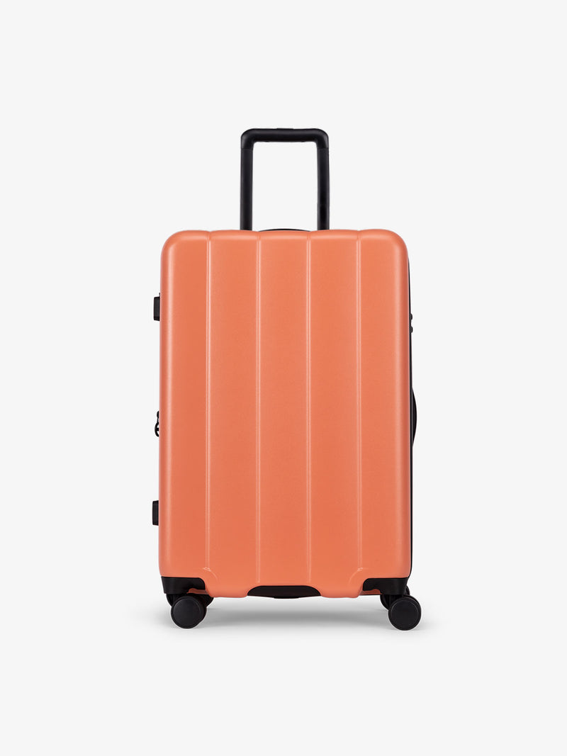 CALPAK Persimmon medium luggage made from an ultra-durable polycarbonate shell and expandable by up to 2"