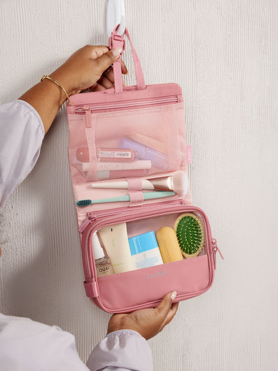 Front view of CALPAK Fit Hanging Dopp Kit made of recycled polyester and features a buckle front closure in tea rose; TFH2401-TEA-ROSE, TFH2401-TEA-ROSE-GRIN view 2