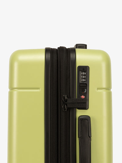 CALPAK green Hue rolling carry-on suitcase with TSA locks
