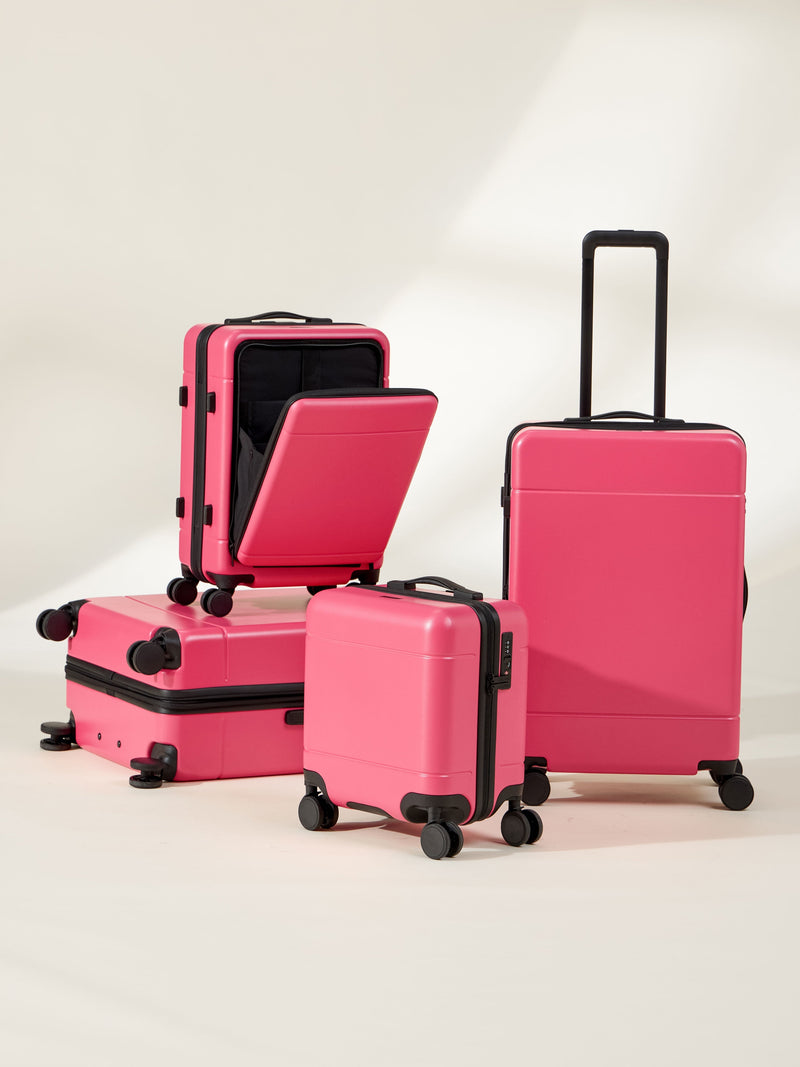 CALPAK Hue Full Luggage Set including Front Pocket Carry On, Mini Carry On, Carry On, and Large Luggage in bright pink dragonfruit