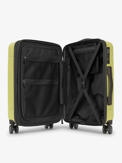 Key lime green CALPAK Hue hardside carry on suitcase with laptop compartment and compression straps