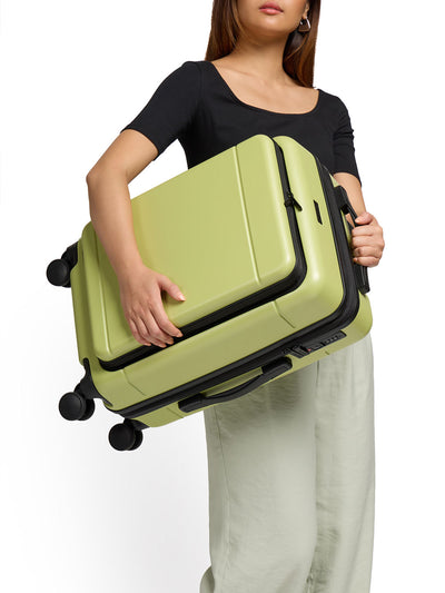 Model holding lightweight CALPAK Hue front pocket carry-on luggage