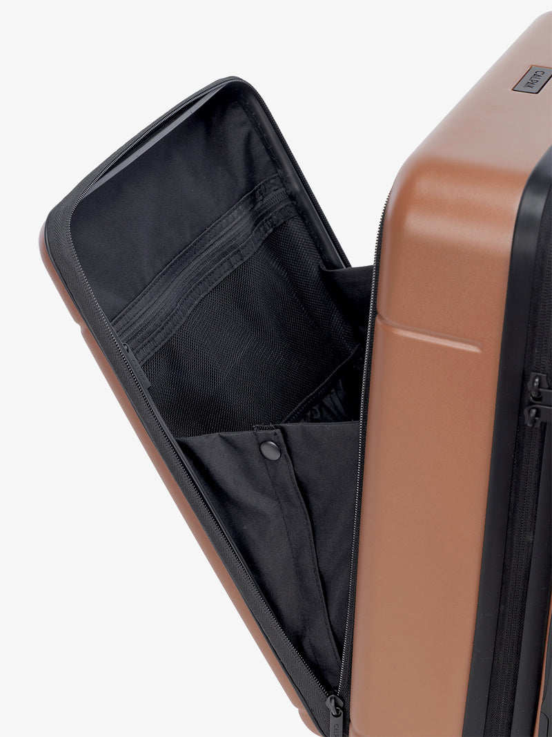 the laptop compartment of CALPAK Hue carry-on suitcase in brown hazel color