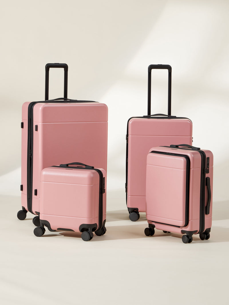 CALPAK Hue Full Luggage Set including Front Pocket Carry On, Mini Carry On, Carry On, and Large Luggage in blush pink mauve