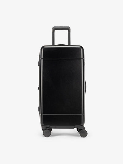 CALPAK Hue Medium Trunk Luggage with durable hard-shell exterior, cushioned top handle and 360 spinner wheels in black; LHU1026-BLACK view 1