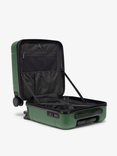 CALPAK Hue small carry-on featuring compression straps in green