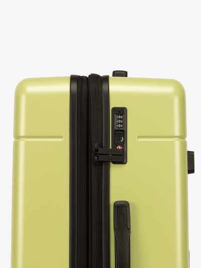 Green CALPAK Hue trunk luggage with built in TSA approved lock