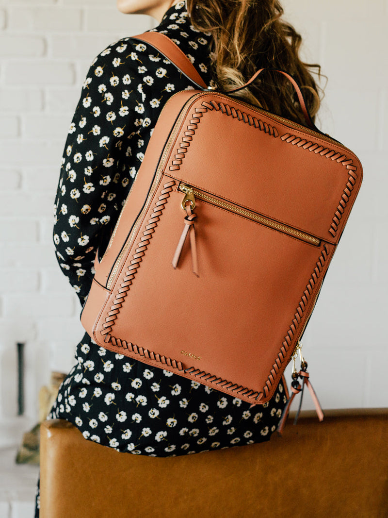 female model with terracotta CALPAK Kaya backpack for women