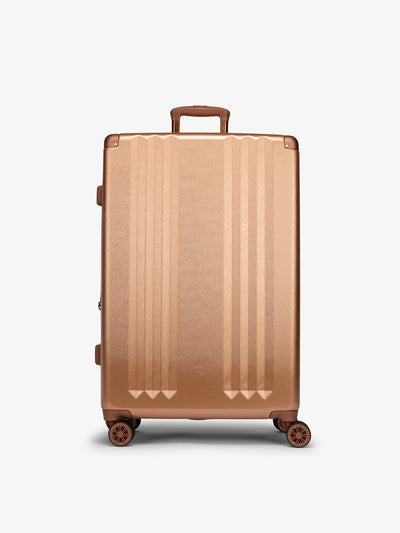 Studio product shot of front-facing CALPAK Ambeur large 30-inch hardshell luggage with 360 spinner wheels in copper; LAM1028-COPPER