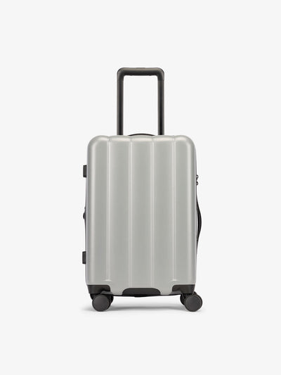 CALPAK Smoke gray carry-on luggage made from an ultra-durable polycarbonate shell and expandable by up to 2"