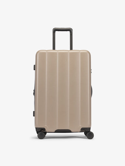CALPAK Brown chocolate medium luggage made from an ultra-durable polycarbonate shell and expandable by up to 2