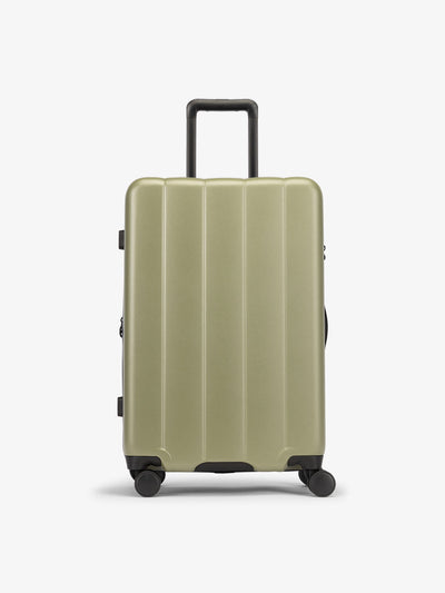 CALPAK Green pistachio medium luggage made from an ultra-durable polycarbonate shell and expandable by up to 2"