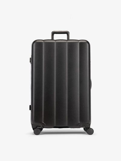 Black CALPAK large luggage made from an ultra-durable polycarbonate shell and expandable by up to 2"