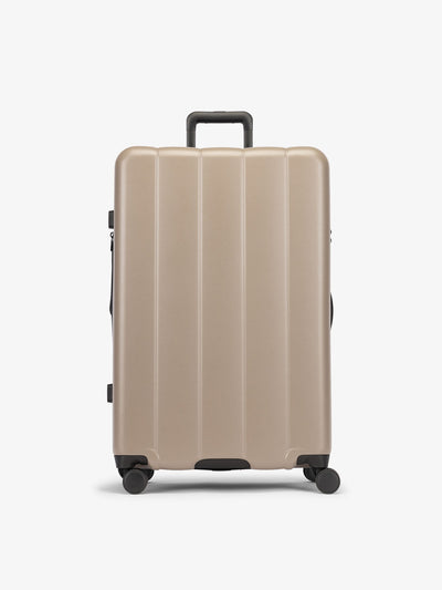 CALPAK Brown chocolate large luggage made from an ultra-durable polycarbonate shell and expandable by up to 2