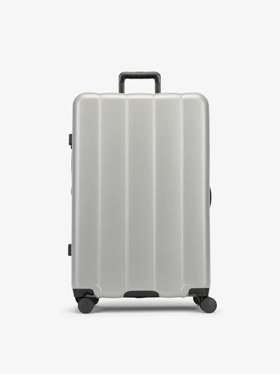 CALPAK Gray smoke large luggage made from an ultra-durable polycarbonate shell and expandable by up to 2"