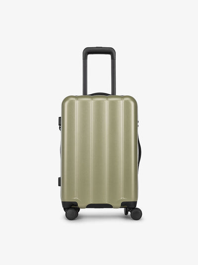 Pistachio green CALPAK carry-on luggage made from an ultra-durable polycarbonate shell and expandable by up to 2