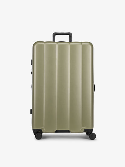 CALPAK Pistachio green large luggage made from an ultra-durable polycarbonate shell and expandable by up to 2"