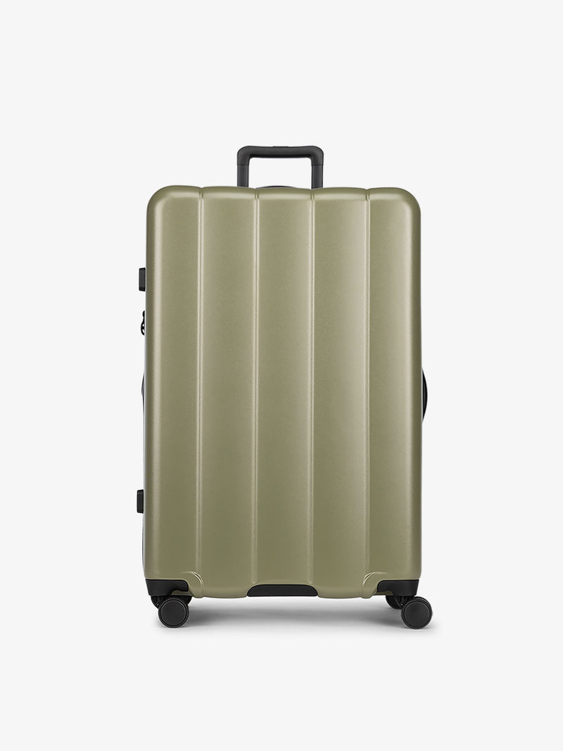 CALPAK Pistachio green large luggage made from an ultra-durable polycarbonate shell and expandable by up to 2"