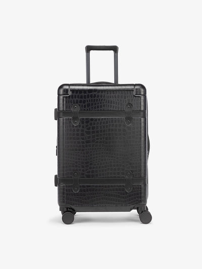 CALPAK TRNK medium 25 inch luggage with 360 spinner wheels and faux crocodile design in vintage trunk style in Black; LTK1024-BLACK-CROC