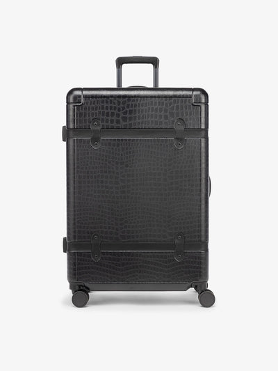 large 29 inch black hard shell CALPAK TRNK suitcase with four 360 wheels in vintage trunk style; LTK1028-BLACK-CROC