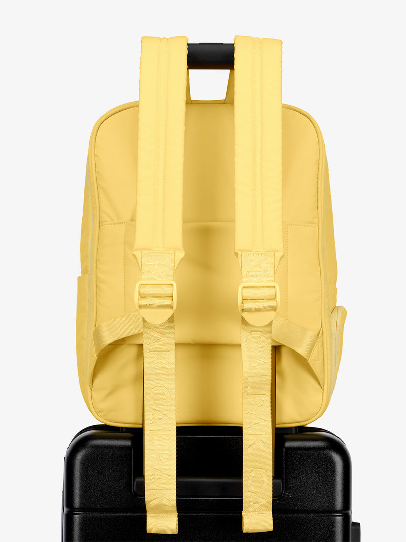 CALPAK water resistant Luka Laptop Backpack with adjustable shoulder straps and trolley sleeve in yellow