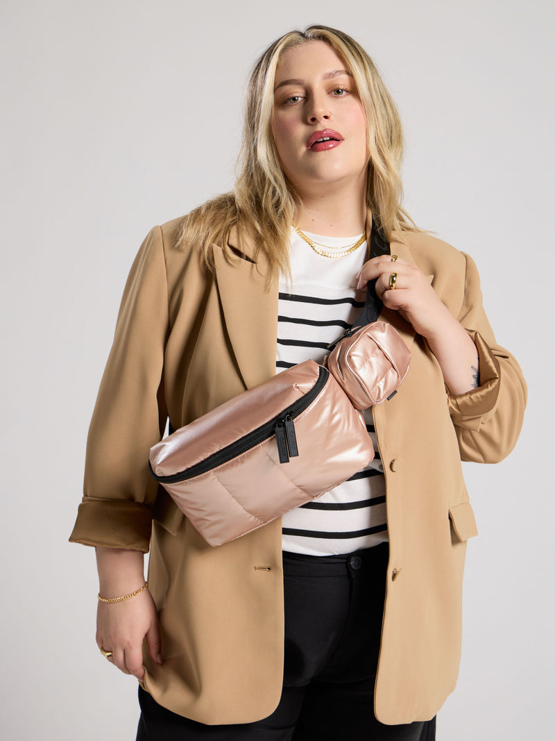 CALPAK Model wearings rose gold Luka Belt Bag as crossbody bag