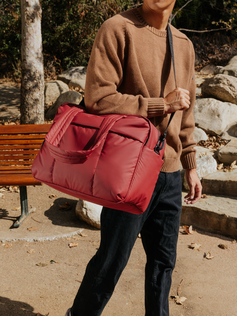 CALPAK Luka Duffel Bag side view with strap in merlot