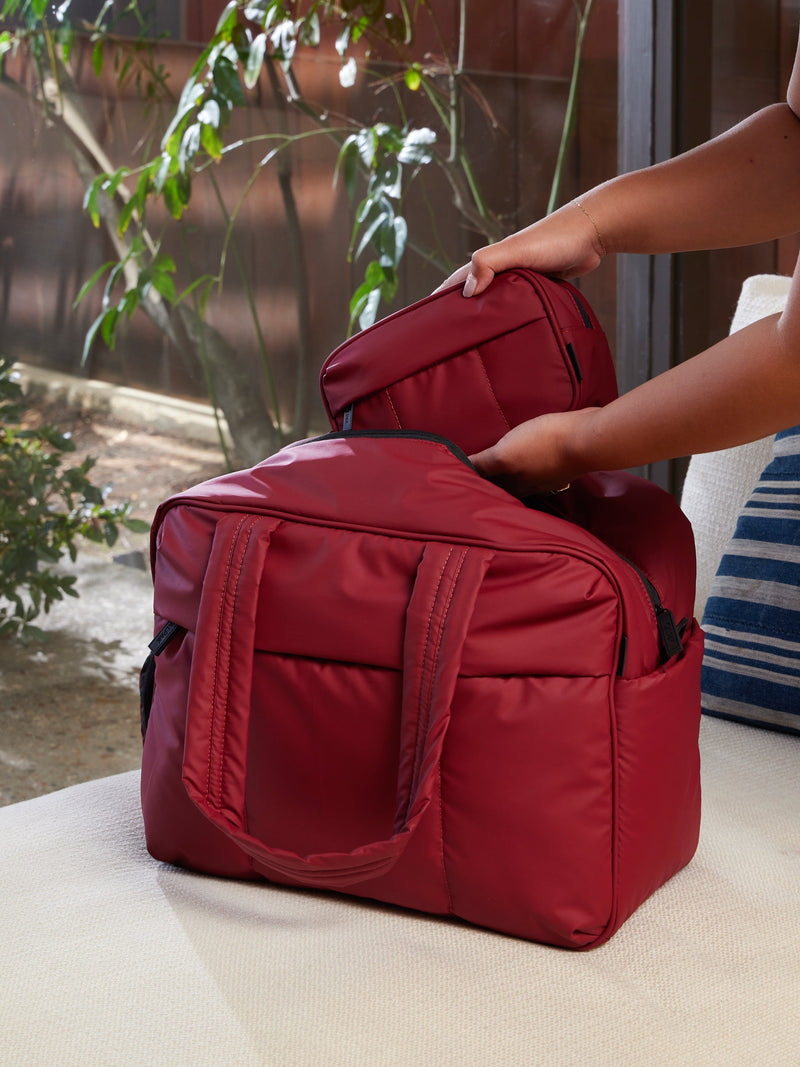 CALPAK Luka Duffel Bag front view in merlot