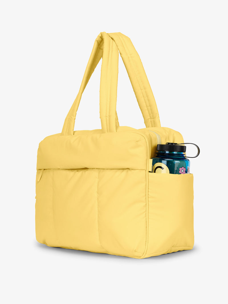 CALPAK Luka Duffel bag with exterior side pocket for large water bottles in butter