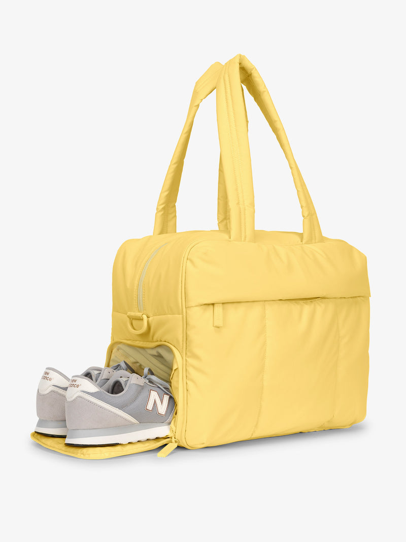 Shoe compartment of CALPAK Luka Duffel Bag in yellow