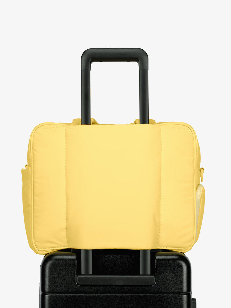 CALPAK Luka Duffel bag with luggage trolley sleeve in yellow butter