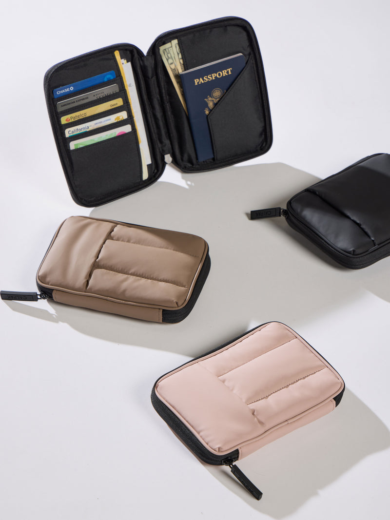 CALPAK Luka Zippered Passport Wallets in chocolate, matte black, and rose quartz